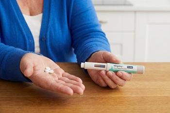 Woman holding Wegovy tablets and injection