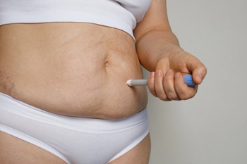 obese woman injecting medication